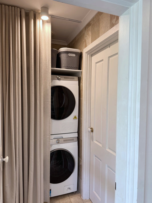 Utility made-to-measure curtain screening a laundry nook